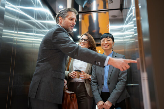 Business meeting in an elevator with three people