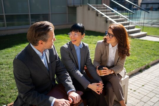 Group of people having a discussion on a sunny day