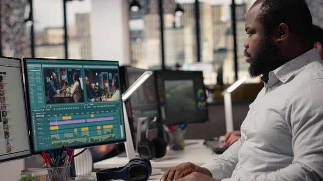 Black videographer editing raw video footage and adjusting sliders on PC software, visual effects and color grading used for movie making in post production. Staff cutting frames and clips.