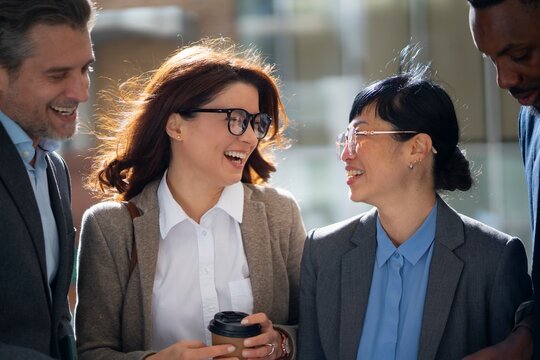 Friends chat outside an office