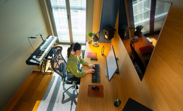 Creative professional working in organized home studio