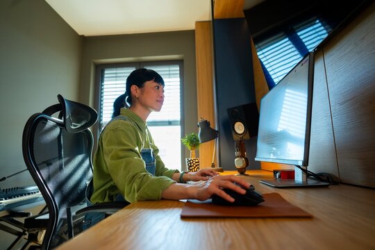 Young woman working on computer at home desk