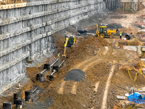 Infrastructure and Retaining Wall Work with Excavators on Construction