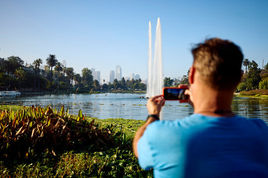 Man snaps photos in Lake Echo Park, Los Angeles
