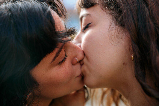 Same Sex Couple Sharing a Kiss Outdoors