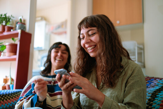 Couple Laughing With Smartphone