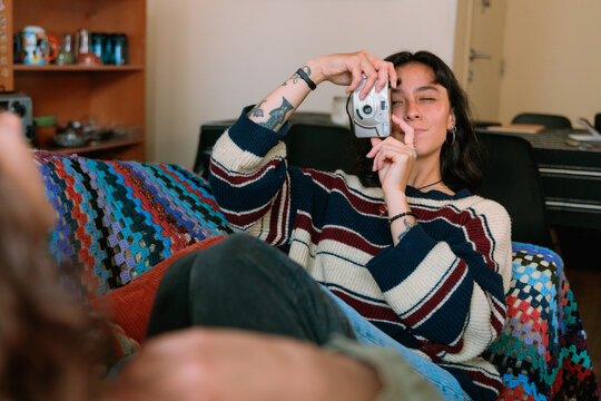 Woman Taking Photo with Compact Camera