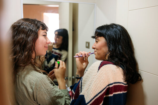 Couple Brushing Teeth Together