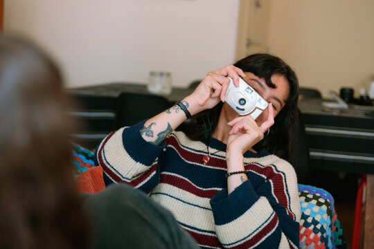 Woman Framing Photo with Point and Shoot Camera