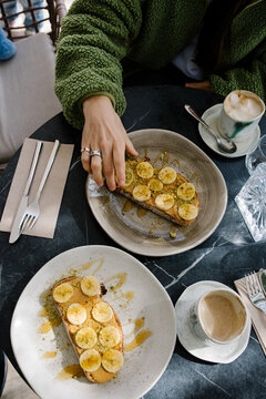 Table with coffee cups and prepared bread slices