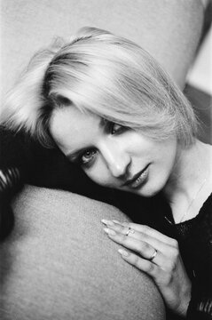 Close-Up Blonde Resting Head on Sofa Arm, B&W Film Portrait