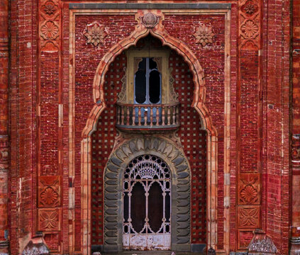 Aerial view of the ornate Moorish facade of Sammezzano Castle with its intricate red brickwork and decorative arched balcony in Reggello, Tuscany, Italy.