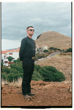 Man Standing on Hill Overlooking Madeira Coastal Village