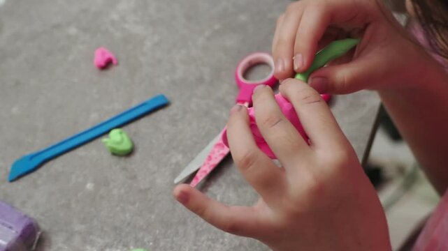 Little girls sculpt figurines crafts from air plasticine, modeling dough. Online lessons in tablet. Children's creativity hobby developing activities, training, learn of fine motor skills of hands.