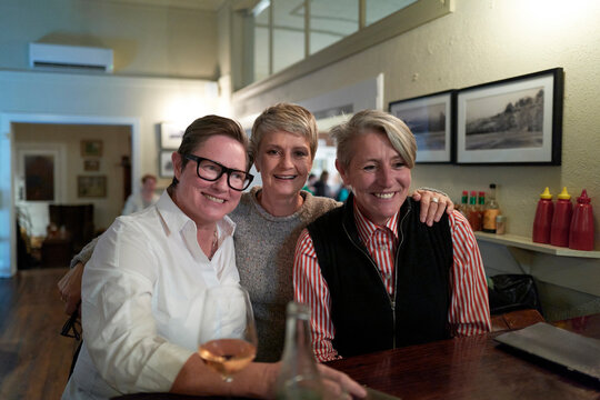 Friends Enjoy Drinks Together at a Bar in the Evening
