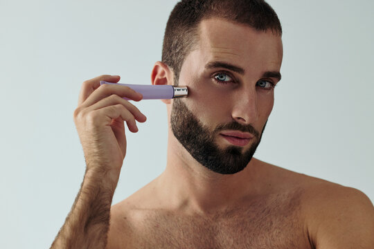 Man Demonstrates Skincare Routine at Home in Natural Light