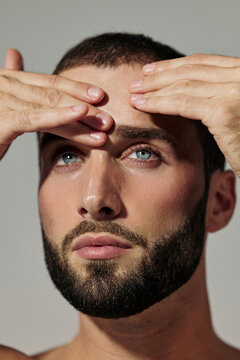 Man Touching His Forehead While Looking Straight Ahead