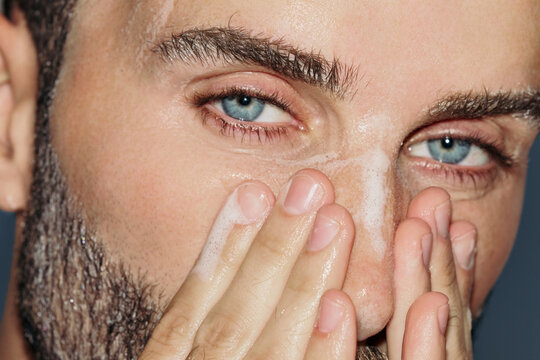 Man Washes His Face in a Bathroom at Morning Time