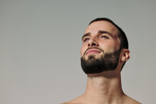 Man Looking up at the Sky With Beard and Short Hair in the Sunlight
