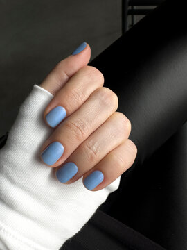Blue color nails manicure closeup