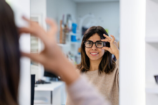 Customer Holding Frames In Eyewear Store
