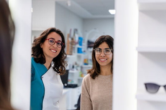 Optician And Customer Posing In Mirror