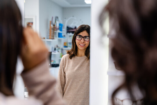 Customer Looking In Mirror Wearing Glasses