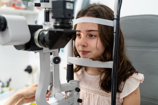Teen Girl Having Eye Exam At Slit Lamp