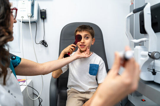 Boy Covering Eye During Exam