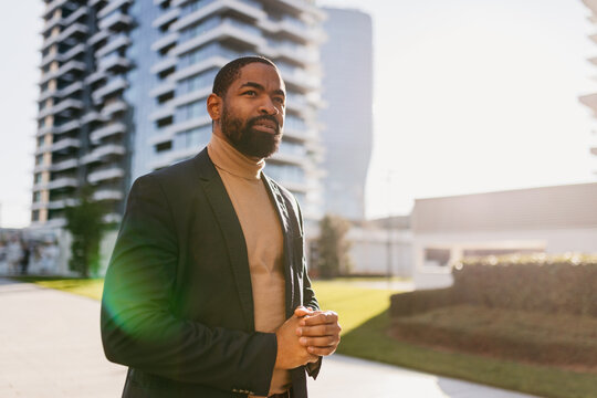 Elegant man stands outdoors