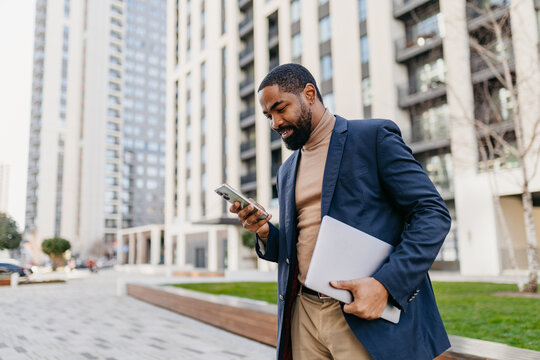 Businessman checks his mobile phone in the city