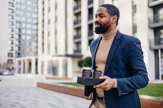 Stylish man carries takeaway coffee