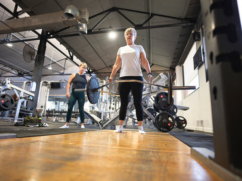 Weightlifting at the Gym With Guidance of Personal Trainer