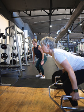 Lifting weights with guidance of Personal Trainer