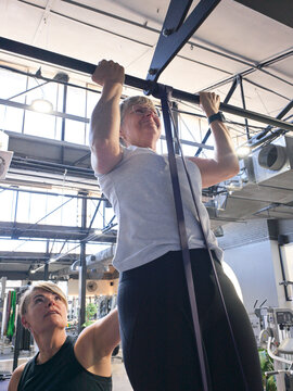 Working out in a Gym With Support from Personal Trainer