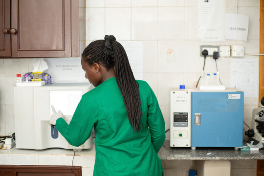 Female Scientist Using Laboratory Analyzer