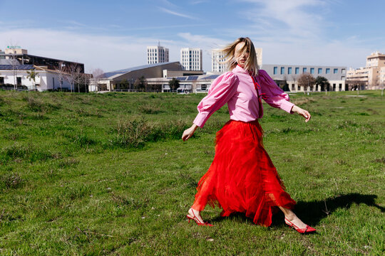 Woman walking in urban green space