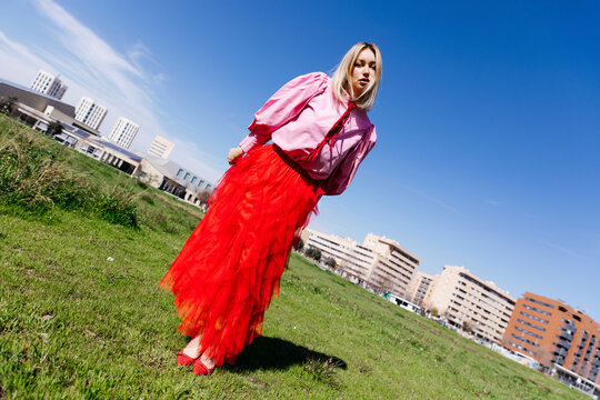 Woman dressing colorful fashion in urban park