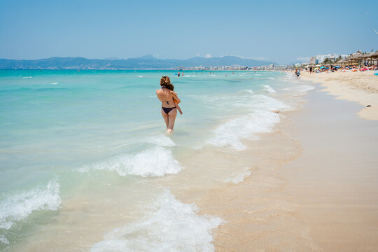 A woman with her son at the beach in summer