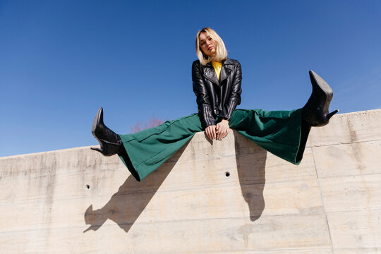 Woman sitting on spreading legs