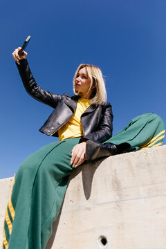 Woman taking selfie with phone 