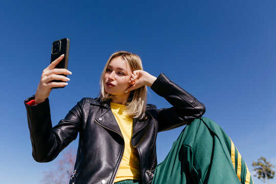 Woman taking selfie with smartphone 