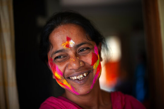 Colourful face smudged with colourful powders in holi festival