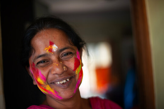 Colourful face smudged with colourful powders in holi festival
