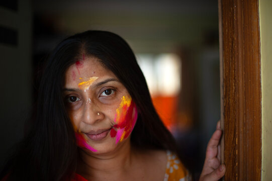 Middle aged Indian woman portrait face smudged with multicolour