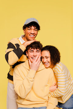 Cheerful friends on yellow background