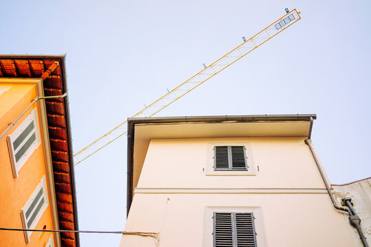 Low angle shot of a crane above buildings