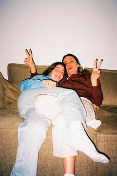 Fun mother and daughter on sofa