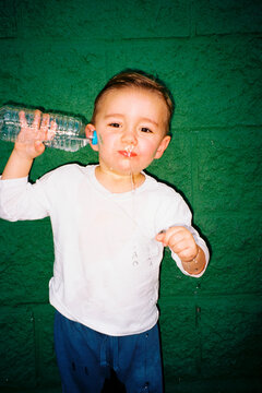 oddler squirting water from mouth