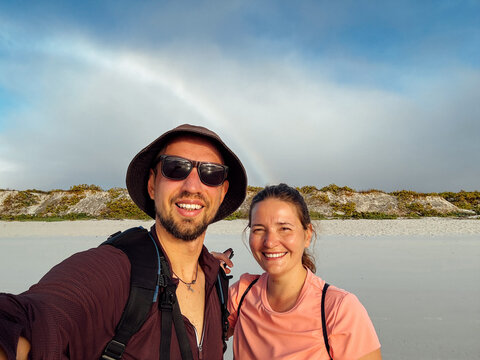 Smiling Couple Taking Selfie on Sunny Beach